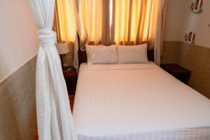 Postel nebo postele na pokoji v ubytování Anh Dao Mekong Hotel