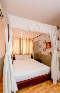 Postel nebo postele na pokoji v ubytování Anh Dao Mekong Hotel