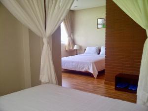 Postel nebo postele na pokoji v ubytování Anh Dao Mekong Hotel