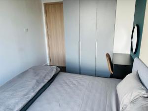 a small bedroom with a bed and a cabinet at Sun Avenue - Cozy apartment with river view in Ho Chi Minh City +15 photos