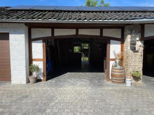 a brick building with a entry way with a door at Bien-Être au B in Sart-lez-Spa