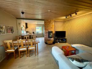 a living room with a table and a dining room at Fredriksberg Säfsen in Fredriksberg