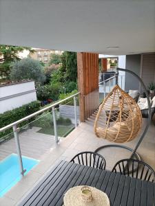 a balcony with a table and chairs and a hammock at Lake Dream Apartment with Pool in Bardolino in Bardolino