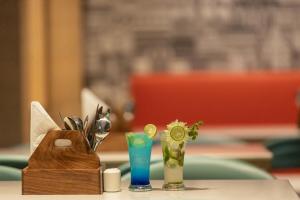 a table with utensils and a vase on it at HOTEL SURYA GRAND in Siliguri +15 photos