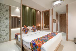 a bedroom with a large bed in a room at FabHotel Melody Boutique - Village Vadavali, Thane in Thane