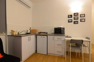 a small kitchen with a counter and a microwave at Arlozorov Bat Yam Beach in Bat Yam