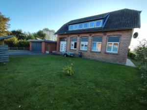 a large brick house with a grass yard at Alte Schule in Altratjensdorf
