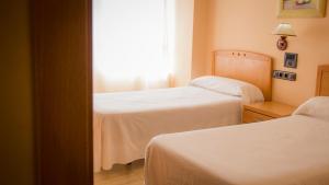 Postel nebo postele na pokoji v ubytování Hostal Meseguer