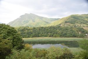 a view of a lake with mountains in the background at Vila Lena in Međuvršje