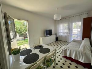a room with a table and a bed and a window at A due passi dal mare in Santa Marinella