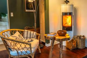 a living room with a chair and a fireplace at TROMSØ AURORA VILLA - Parking - Near Centrum in Tromsø
