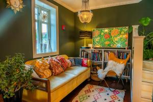 a living room with a couch and a book shelf at TROMSØ AURORA VILLA - Parking - Near Centrum in Tromsø