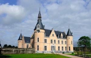 a large castle with a tower on top of it at Grange de la Rochette - 1 à 6p in Jamoigne