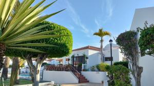 a view of a building with trees and plants at Costa Adeje Heated Pool Marina Primavera in Adeje