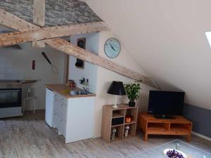 a kitchen with a counter and a clock on the wall at La Spinette in Hastière-Lavaux