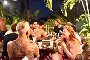 a group of people sitting at tables at a restaurant at Rio Forest Hostel in Rio de Janeiro