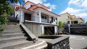 a house with stairs in front of it at NostraCasa by LovelyStay in Caniço