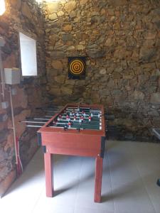 a wooden chess board in a room with a stone wall at Casa de Cardigos in Cardigos +82 photos