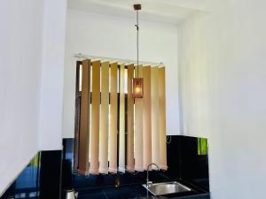 a chandelier hanging over a sink in a kitchen at Adithya Seaview Villa - Tangalle in Tangalle +67 photos