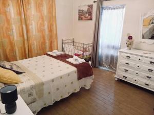 a bedroom with a bed and a dresser and a window at Casa Glória in Cabeceiras de Basto