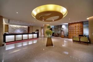 a large lobby with a large gold ceiling at Vivanta Goa, Panaji in Panaji