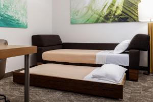 a room with three beds and a chair at SpringHill Suites by Marriott Sacramento Roseville in Roseville +21 photos
