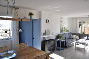 a living room with a blue cabinet and a couch at Chalet Christine in Petten