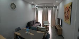a living room with a table and a couch at Cosy 3bedroom apartment in Flic-en-Flac