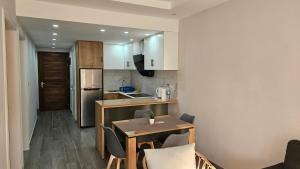 a small kitchen with a table and chairs in a room at Cosy 3bedroom apartment in Flic-en-Flac +9 photos