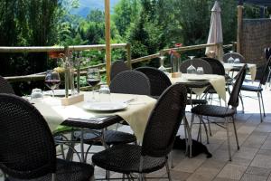 a group of tables and chairs with glasses of wine at Agriturismo Monte Del Re in San Pietro al Natisone