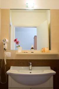 a bathroom with a sink and a mirror at Agriturismo Monte Del Re in San Pietro al Natisone