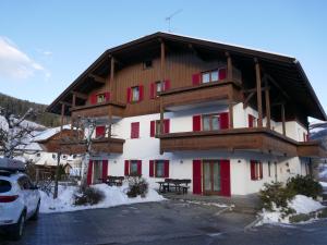 a large building with red and white at Appartement Alpenblick in Valdaora