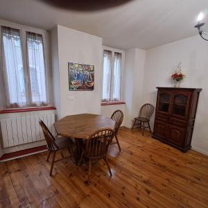 a dining room with a wooden table and chairs at StGoFeelGood in Saint-Gaudens +13 photos