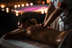 a woman getting a massage from a therapist at Lido Palace - The Leading Hotels of the World in Riva del Garda