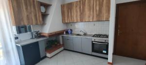 a small kitchen with a sink and a stove at Umbria Tuoro in Tuoro sul Trasimeno