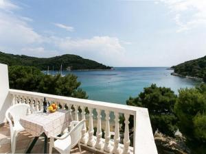 a balcony with a table and a view of the ocean at Apartments Franka Saplunara-One-Bedroom Apartment with Terrace and Sea View No1 in Saplunara