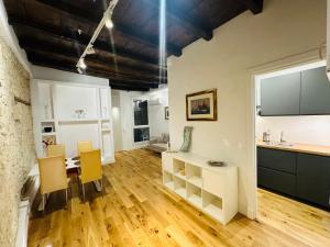 a kitchen and dining room with a table and chairs at Antico Corso Charme in Cagliari