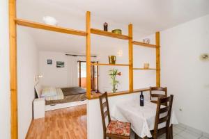 a dining room with a table and chairs and a room at Apartments Bezek - Studio Apartment with Sea View in Trstenik +18 photos
