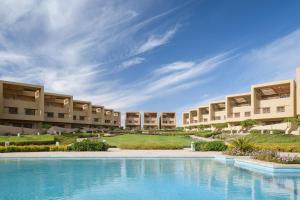 an image of the exterior of a resort with a swimming pool at The Zen Wellness Resort in Aswan