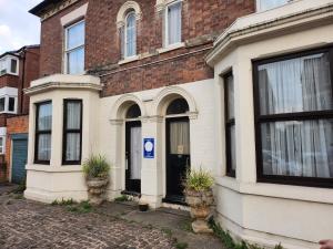 a brick building with a blue parking sign on it at 4 single beds shared bathroom in Nottingham