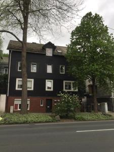 ジーゲンにあるSiegen Zentral Ferienwohnung 1 bis zum12 Schlafplätzeの上に時計がある黒い家