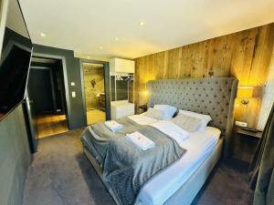 a bedroom with a large bed with two towels on it at Lou Alpen Chalet in Reith bei Seefeld