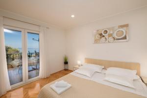Postel nebo postele na pokoji v ubytování Apartmani Marta