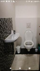 a bathroom with a toilet and a sink at Luxusní byt v centru - Free Parking in Karlovy Vary