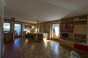 a living room with a kitchen and a dining room at Villa Tamion in Vigo di Fassa