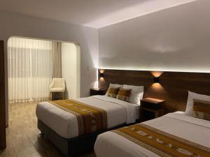 Postel nebo postele na pokoji v ubytování Hotel Rumi