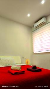 a bedroom with a red bed with a red blanket at One bedroom TEA apartment Il-Gzira in Il-Gżira