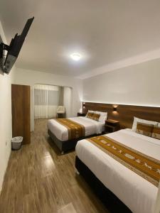 Postel nebo postele na pokoji v ubytování Hotel Rumi