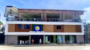 two women walking in front of a building at Boracay Grace Hotel in Boracay