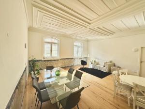 a living room with a table and chairs at Large apartment on Rua Augusta in Lisbon